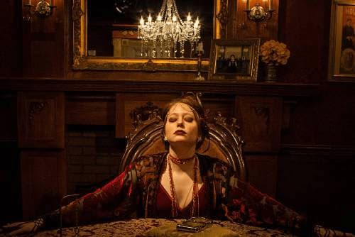 Daphne at the table in the escape room
